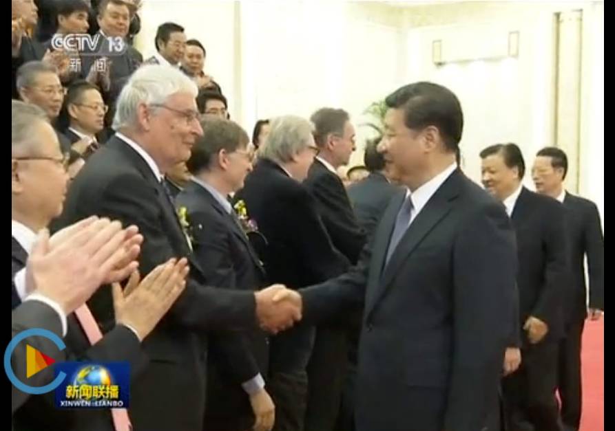 In a still image from a live tv broadcast, Peter Stang shakes hands with Xi Jingping, the President of the People's Republic of China.
